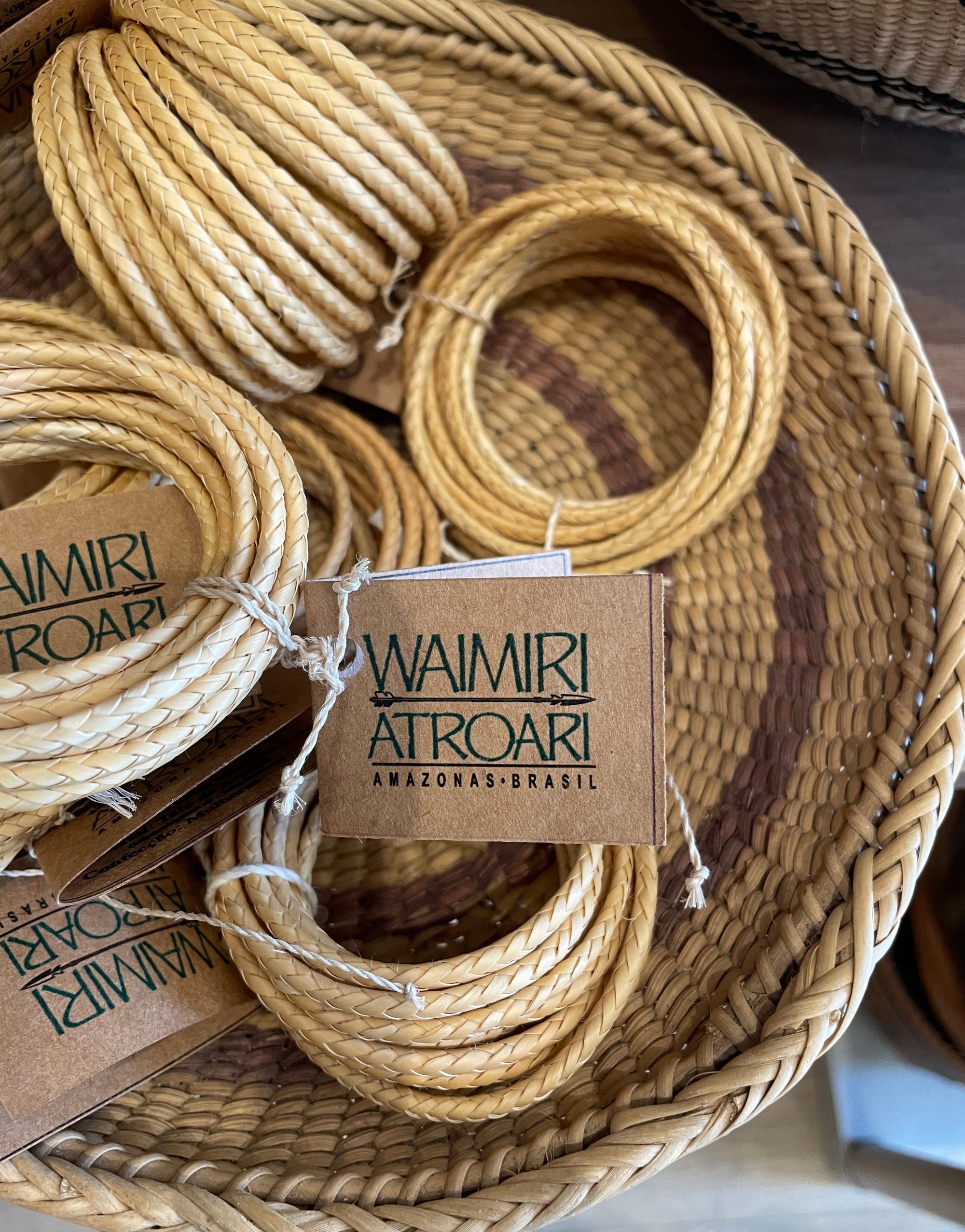 Woven cord with 'Waimiri Afroart' tags inside a woven basket.